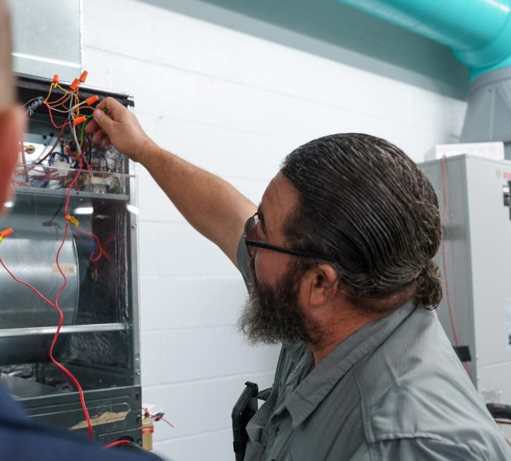 Photo of a Happy Home Services technician working on an oil furnace