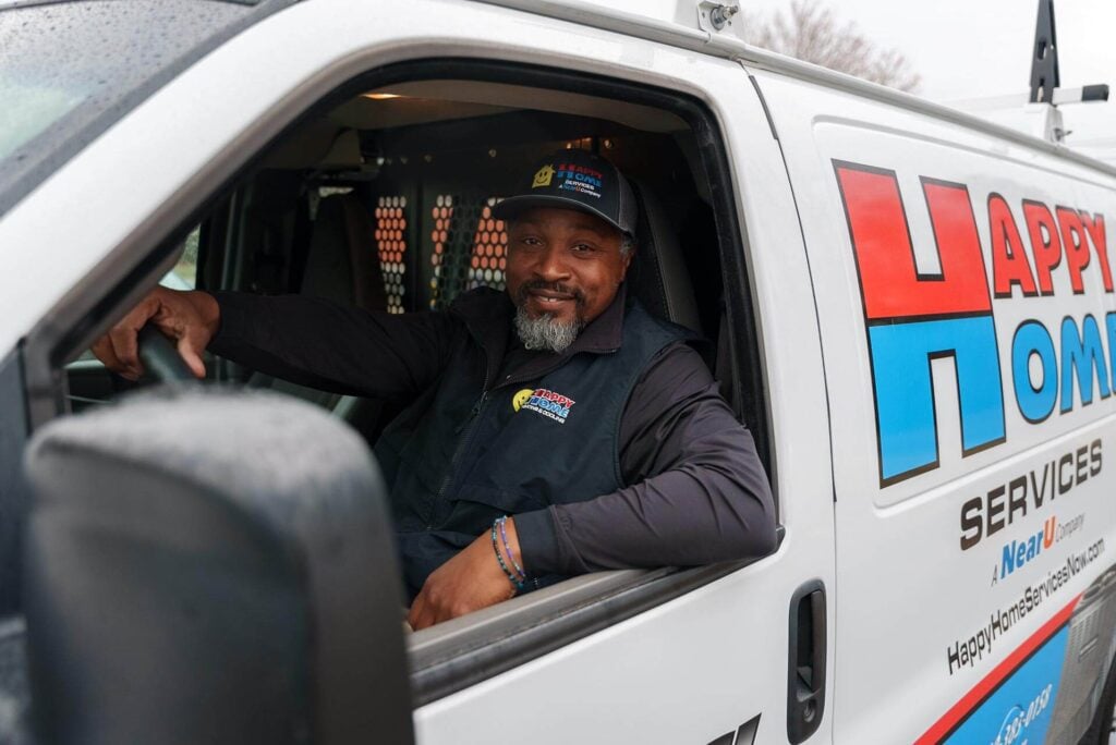 A Happy Home Services technician behind the wheel of a Happy Home Services van - Happy Home Services | Durham, NC A Happy Home Services technician behind the wheel of a Happy Home Services van