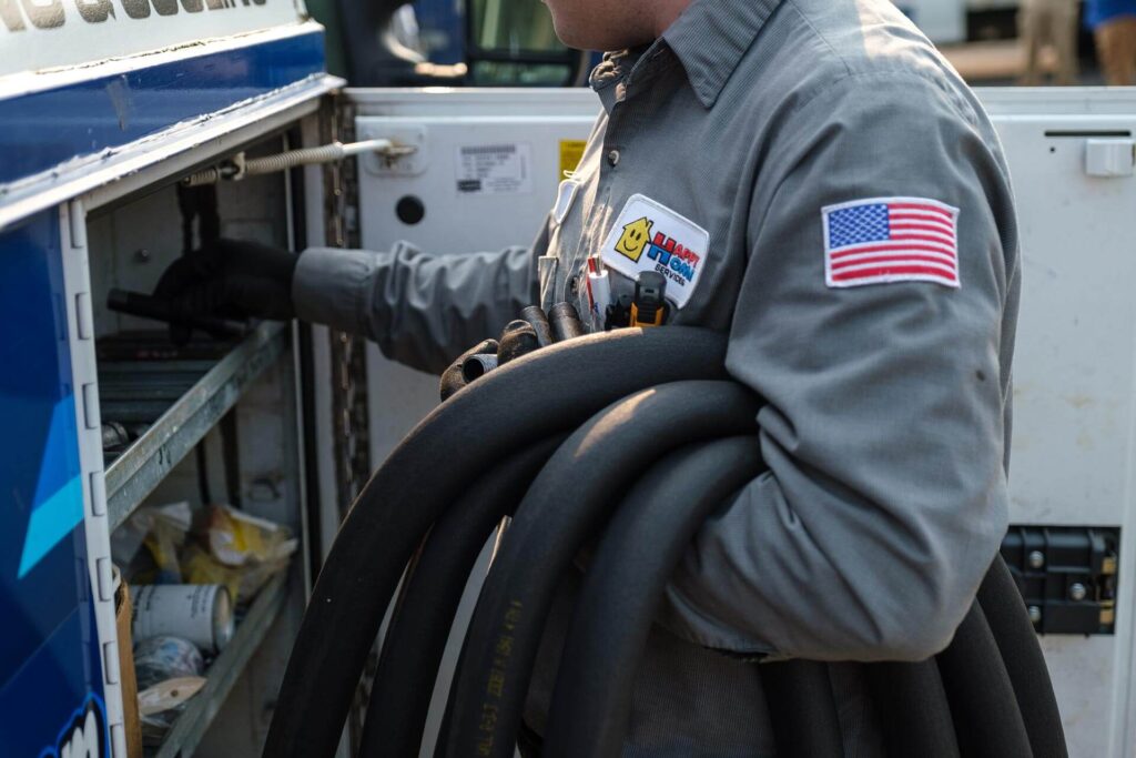 - Happy Home Services | Durham, NC A Happy Home Services technician retrieving tools from the service truck