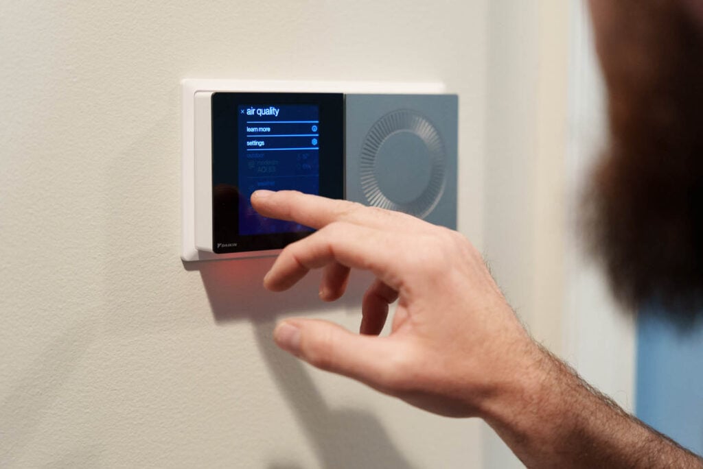 - Happy Home Services | Durham, NC A smart thermostat being operated by a customer in Durham, NC.