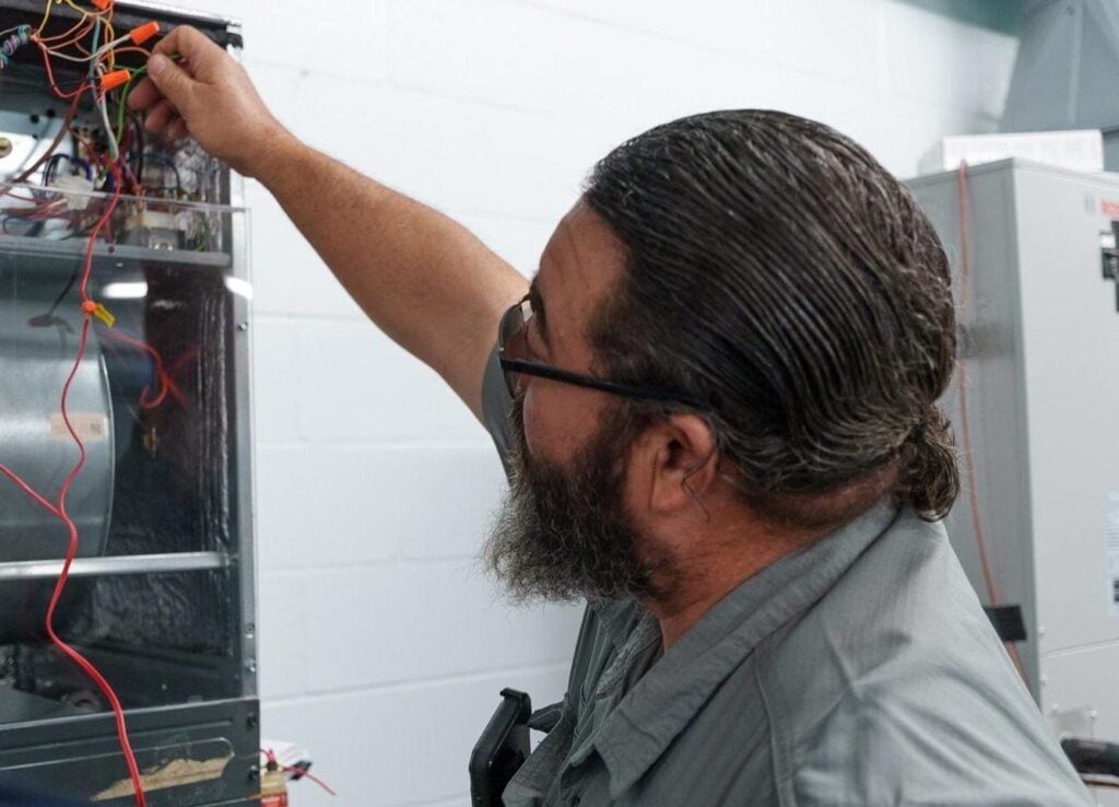- Happy Home Services | Durham, NC Photo of a Happy Home Services technician working on an oil furnace