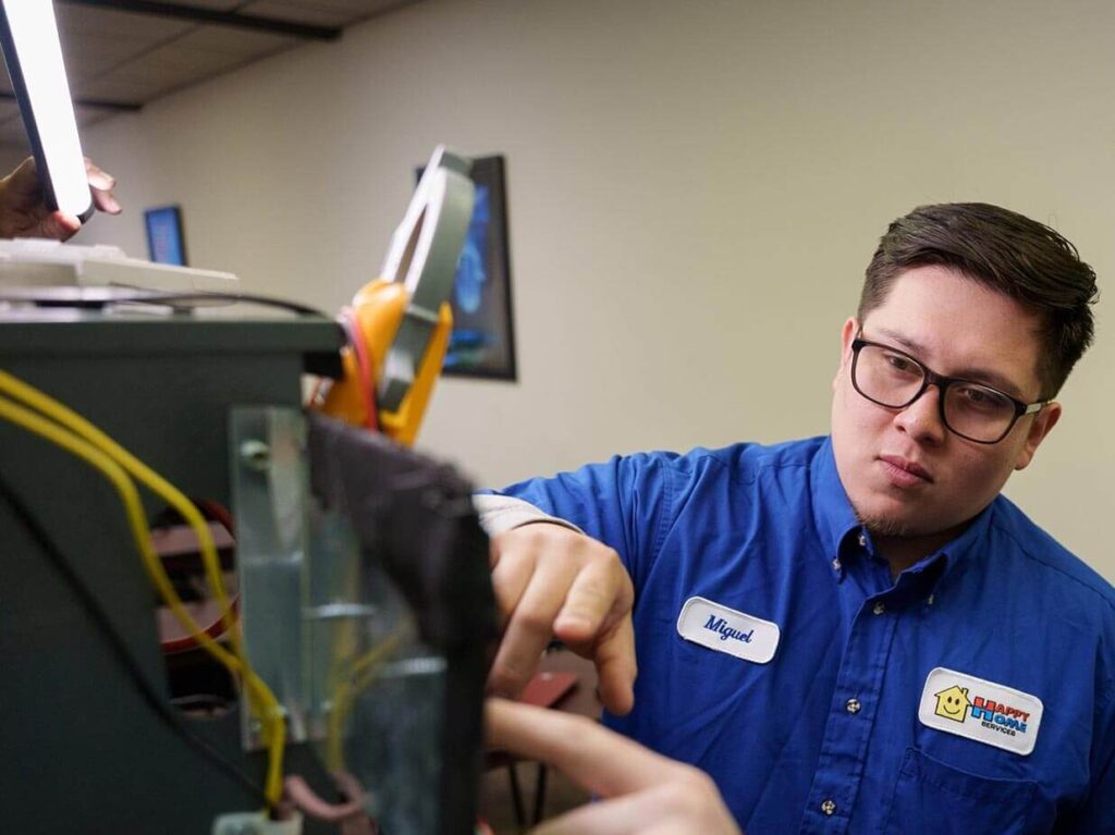 - Happy Home Services | Durham, NC Two-Happy-Home-Services-technician-working-on-a-heating-unit