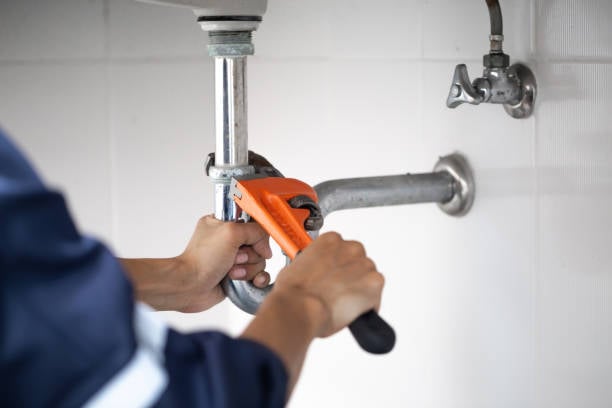 - Happy Home Services | Durham, NC A licensed plumber performing a trap and pipe cleaning service at a customer's home in Durham, NC